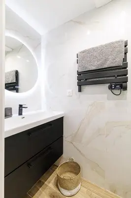 a bathroom with a sink and a mirror at Studio Duplex Carré d'Or in Nice
