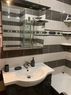 a bathroom with a white sink and a tub at Appartement à 50 mètres de la plage in Cagnes-sur-Mer
