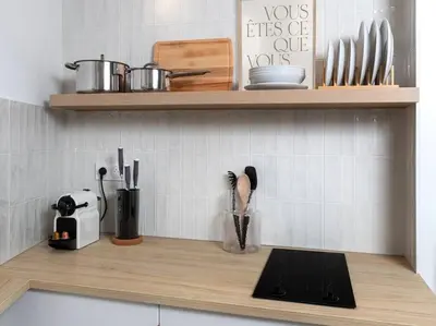 a kitchen counter with utensils on a shelf at Unique Old Town Designer Studio in Nice