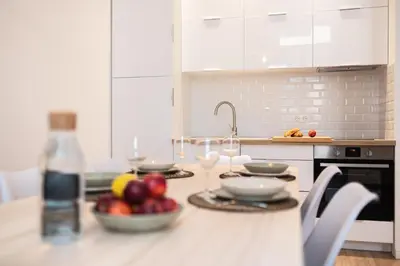 a kitchen with a table with a bowl of fruit on it at Magnifique 2P avec vue sur le port de Nice in Nice