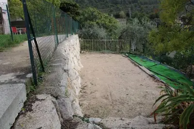 a fence in front of a tennis court at Location 2 pièces sur EZE à 3km de MONACO (2) in Èze