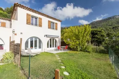 a large white house with a yard at Location 2 pièces sur EZE à 3km de MONACO (2) in Èze