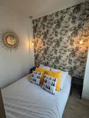 a bed with two pillows on it in a bedroom at appartement carré d'or in Nice