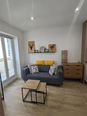 a living room with a couch and a table at appartement carré d'or in Nice