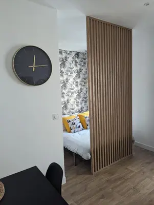 a room with a large mirror and a clock on the wall at appartement carré d'or in Nice