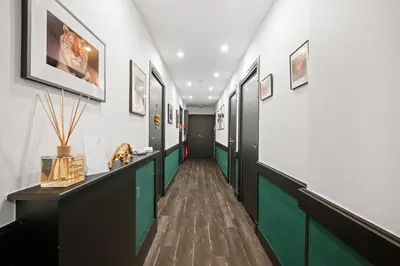 a hallway with green and white walls and pictures on the walls at App-Art in Nice