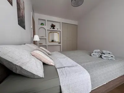 a bedroom with a large bed with white sheets at Oscar in Nice