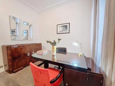 a desk with a red chair and a table with a mirror at Nestor&Jeeves - VICTOIRE - Central - Near Beach in Nice