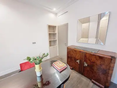a living room with a table and a mirror at Nestor&Jeeves - VICTOIRE - Central - Near Beach in Nice