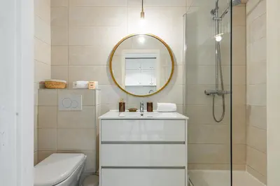 a bathroom with a toilet and a sink and a mirror at Lovely 1 Bdr Port Area in Nice