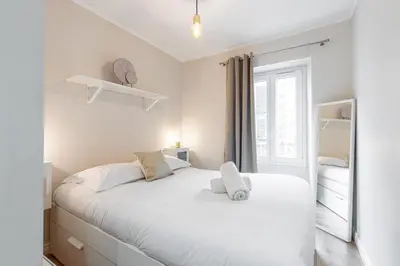 a bedroom with a white bed with a window at Lovely 1 Bdr Port Area in Nice