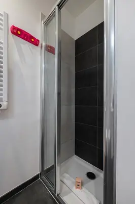 a shower with a glass door in a bathroom at Charming City Center Studio 104 in Nice