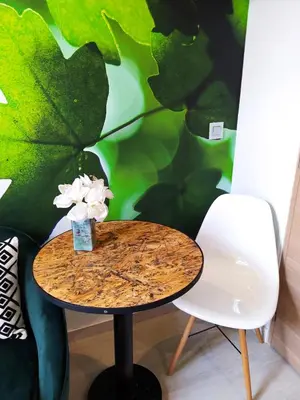 a table and a chair in a room with a wall at Riviera Cocoon - Nice Center in Nice