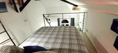 a living room with a plaid couch in a house at Riviera Cocoon - Nice Center in Nice