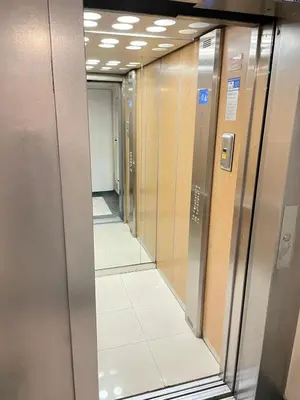 a row of elevators in a hallway at STUDIO SUR LA PROMENADE DES ANGLAIS AVEC VUE MER ORIGINALE À 40 m DE LA PLAGE in Nice