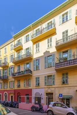 a building with cars parked in front of it at Nice Renting - FODERE - Charm & Comfort 2P Heart of Nice - AC & WiFi in Nice