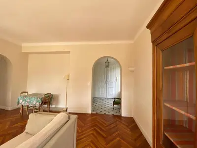 a living room with a couch and a table at PALMERAIE - Magnifique appartement d'époque avec Vue Mer 4 personnes avec terrasse Le Port Nice in Nice