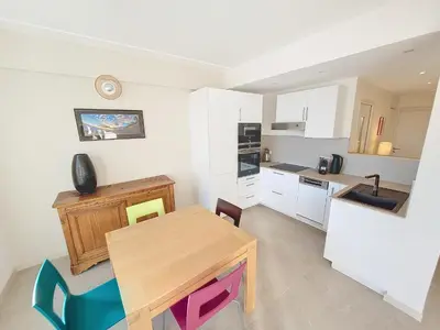 a kitchen with a wooden table and a dining room at Nestor&Jeeves - CIEL AZUR - Terrace in Nice