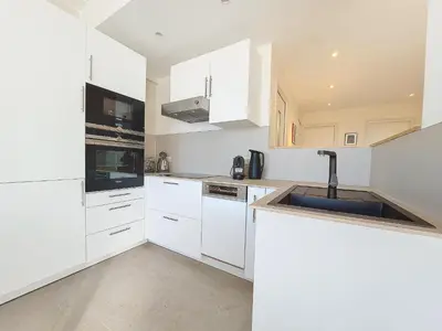 a white kitchen with white cabinets and a sink at Nestor&Jeeves - CIEL AZUR - Terrace in Nice