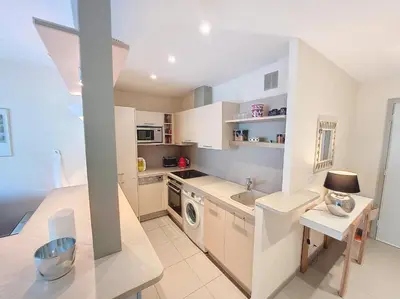 a kitchen with white cabinets and a washing machine at Nestor&Jeeves - BAIETA - Balcony in Nice