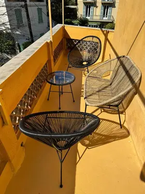 three chairs and tables sitting on a balcony at Le Virenque in Nice