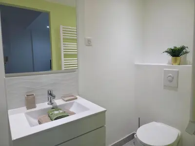 a white bathroom with a sink and a toilet at Le Virenque in Nice