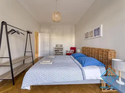 a bedroom with a large bed and a chair at NEW Luxurious apartment - Jean Medecin in Nice