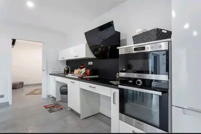 a kitchen with a black and white stove top oven at Gite Mare e Montagne Drap 06 in Drap