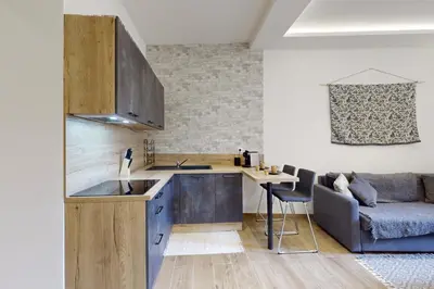 a kitchen with a sink and a table and a couch at Suite Stars FSHH in Nice