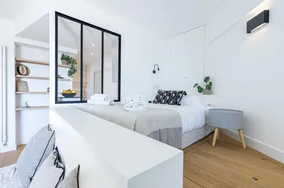 a white bedroom with a bed and a mirror at Franck Pilatte - Parking, Wifi, AC, 3pers in Nice