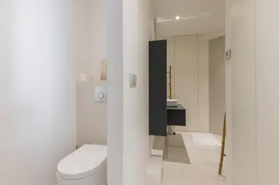 a white bathroom with a toilet and a sink at Franck Pilatte - Parking, Wifi, AC, 3pers in Nice
