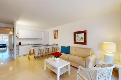 a living room with a couch and a table at Suite Aquarius FSHH in Nice