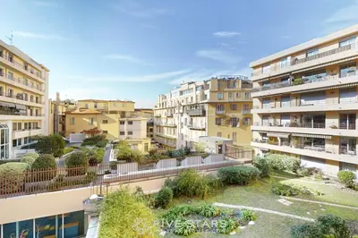 an apartment building with a garden on the balcony at Suite Aquarius FSHH in Nice