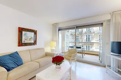 a living room with a couch and a large window at Suite Aquarius FSHH in Nice