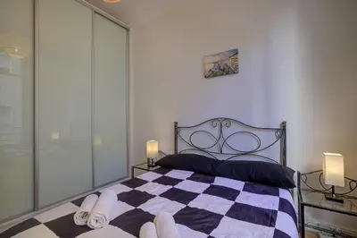 a bedroom with a black and white checkered bed at Maison Bianchi - 187 Promenade des Anglais - Sea view in Nice