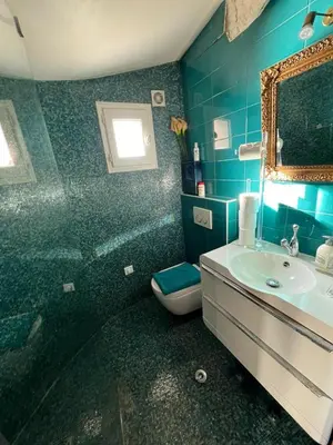 a bathroom with a sink and a toilet and a mirror at Maison de 6 pièces au coeur du village d'Eze in Èze