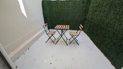 two chairs and a table in front of a wall at COMBOUL in Nice