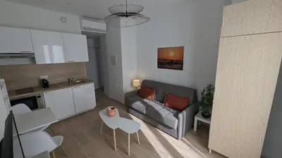 a living room with a couch and a table at COMBOUL in Nice