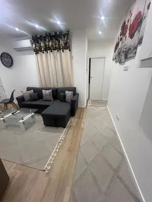 a living room with a couch and a table at Appartement T2 in Nice