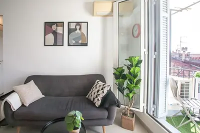 a living room with a couch and a large window at L33 2P Jean Médecin centrale/ 2 Balcony & AC in Nice