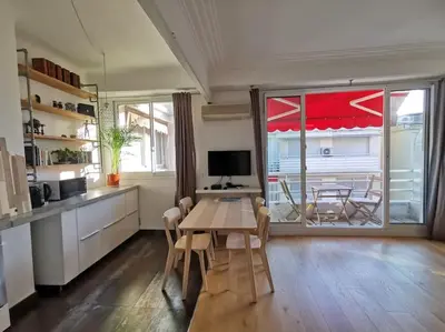a kitchen with a table and chairs and a large window at #TheCosyStudio06 Meyerbeer Promenade Negresco in Nice