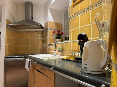 a kitchen with a sink and a coffee maker on a counter at Le ville franche in Villefranche-sur-Mer
