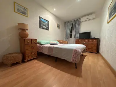 a bedroom with a bed and a dresser and a television at Le ville franche in Villefranche-sur-Mer