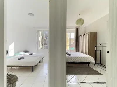 a bedroom with a bed with two slippers on it at Cosy 3 Pièces Proche Mer in Nice