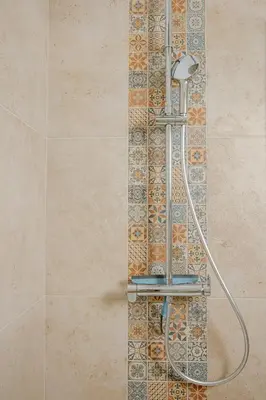 a shower in a bathroom with a tile wall at Serenity chic apartment Nice center in Nice
