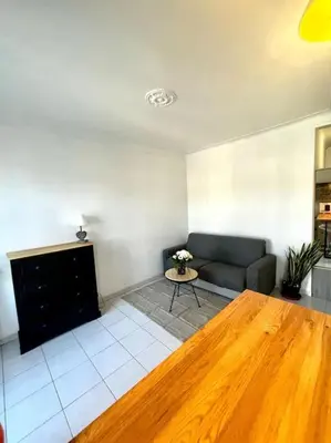 a living room with a couch and a table at Studio de charme hyper centre in Nice