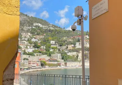 a view of a city from a balcony with a street light at Logement Atypique in Villefranche-sur-Mer