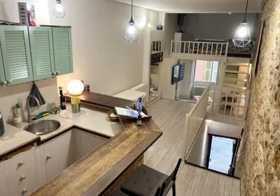 a kitchen with a sink and a counter top at Logement Atypique in Villefranche-sur-Mer