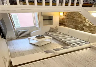 a living room with a couch and a table at Logement Atypique in Villefranche-sur-Mer