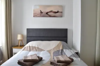 a bedroom with a bed with two pillows on it at Bel appartement au cœur de Nice (2 chambres) in Nice